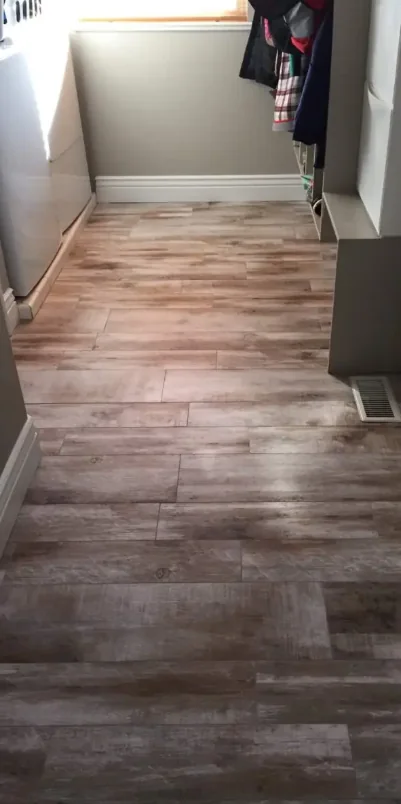 After: new plank flooring installed in a laundry area