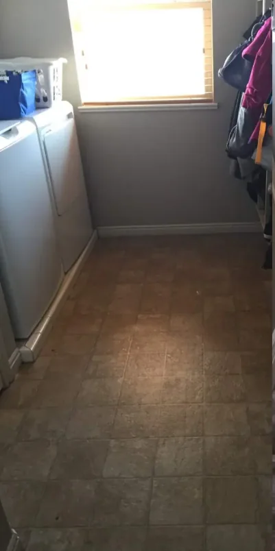 Before: older sheet flooring in a laundry area
