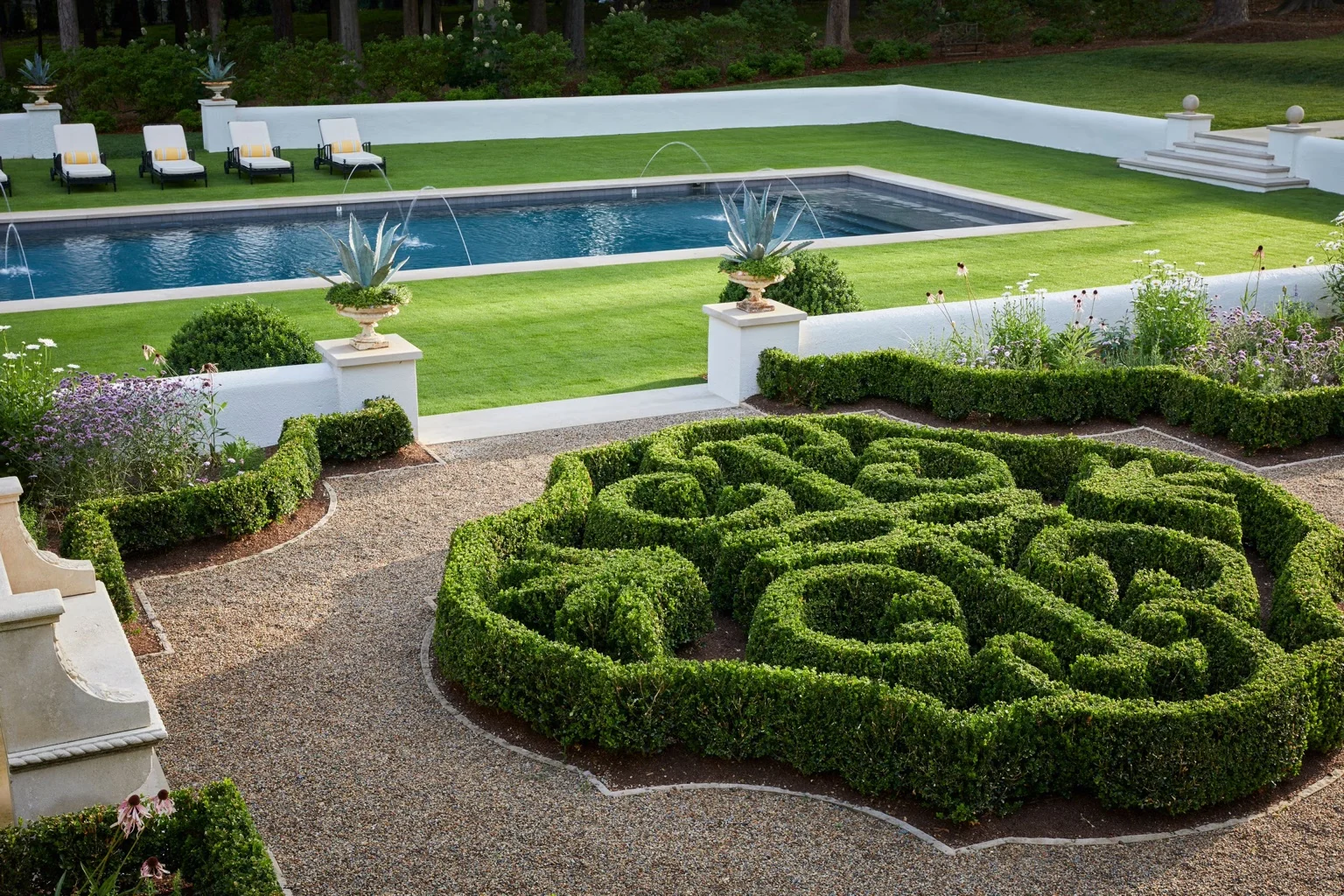 Premium formal landscaping with manicured hedges, gardens and a pool