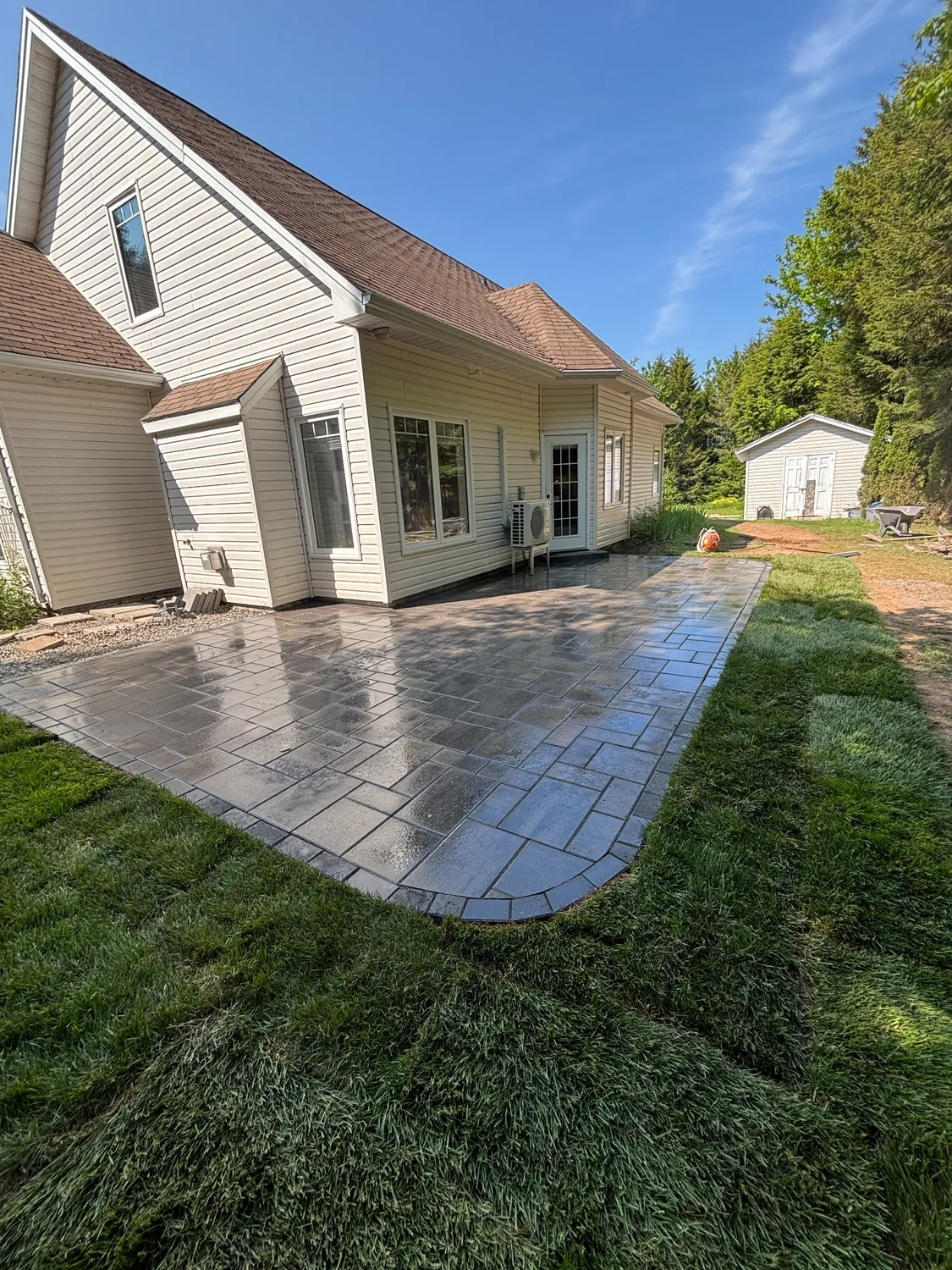 Completed stone patio beside a home