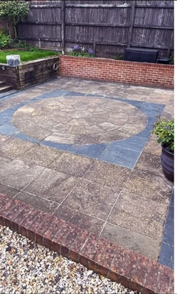 Before: stained and weathered stone patio